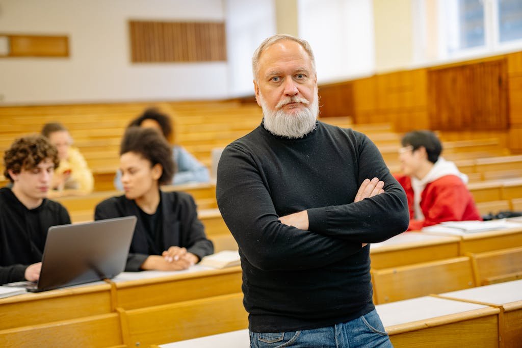 Confident professor in lecture hall with diverse students engaged in learning.